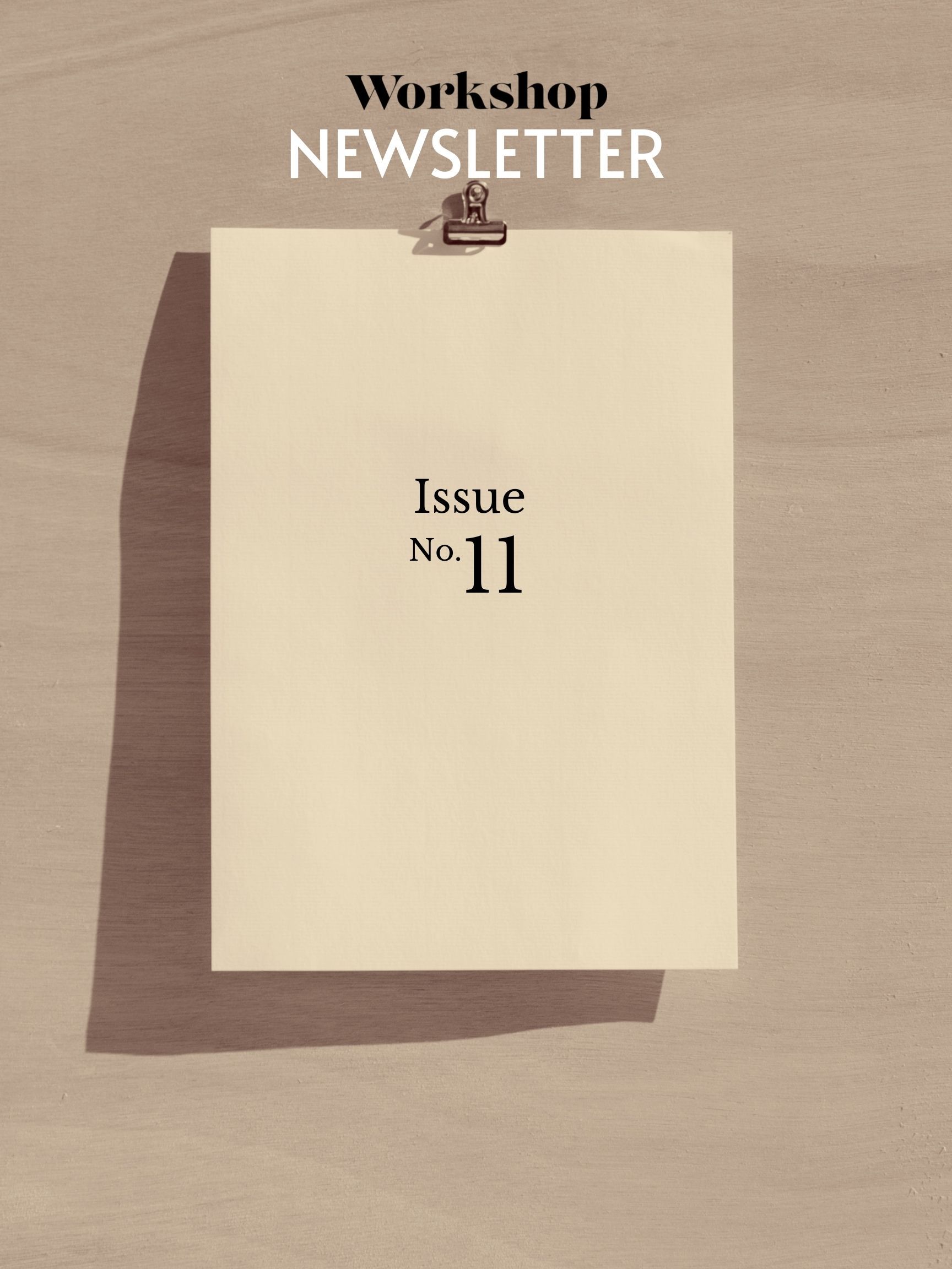 A clipboard on plain background, overlaid in brown. Text reads "Workshop Newsletter Issue No. 11"