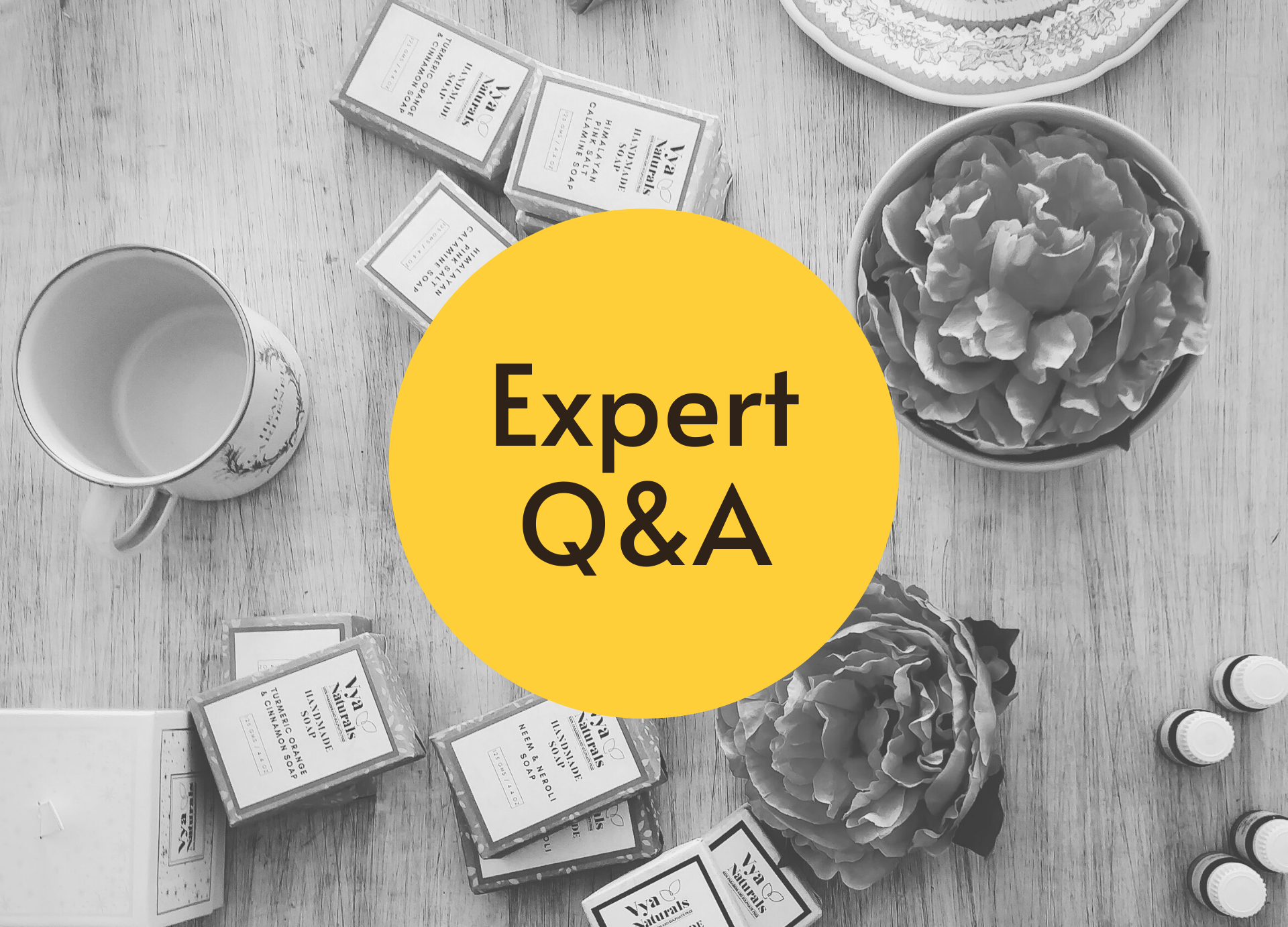 A black-and-white tabletop filled with soap and other products, with the words "Expert Q&A".