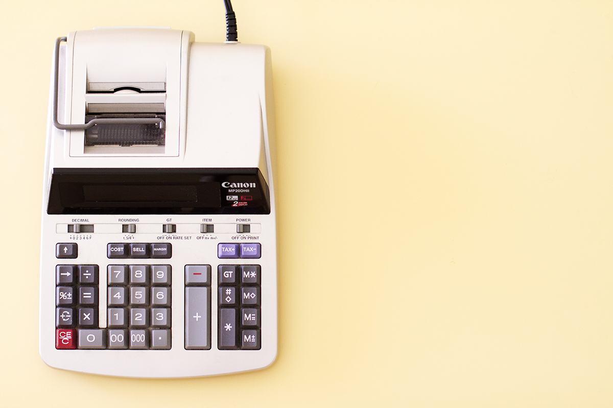A Canon adding machine on a pale yellow background