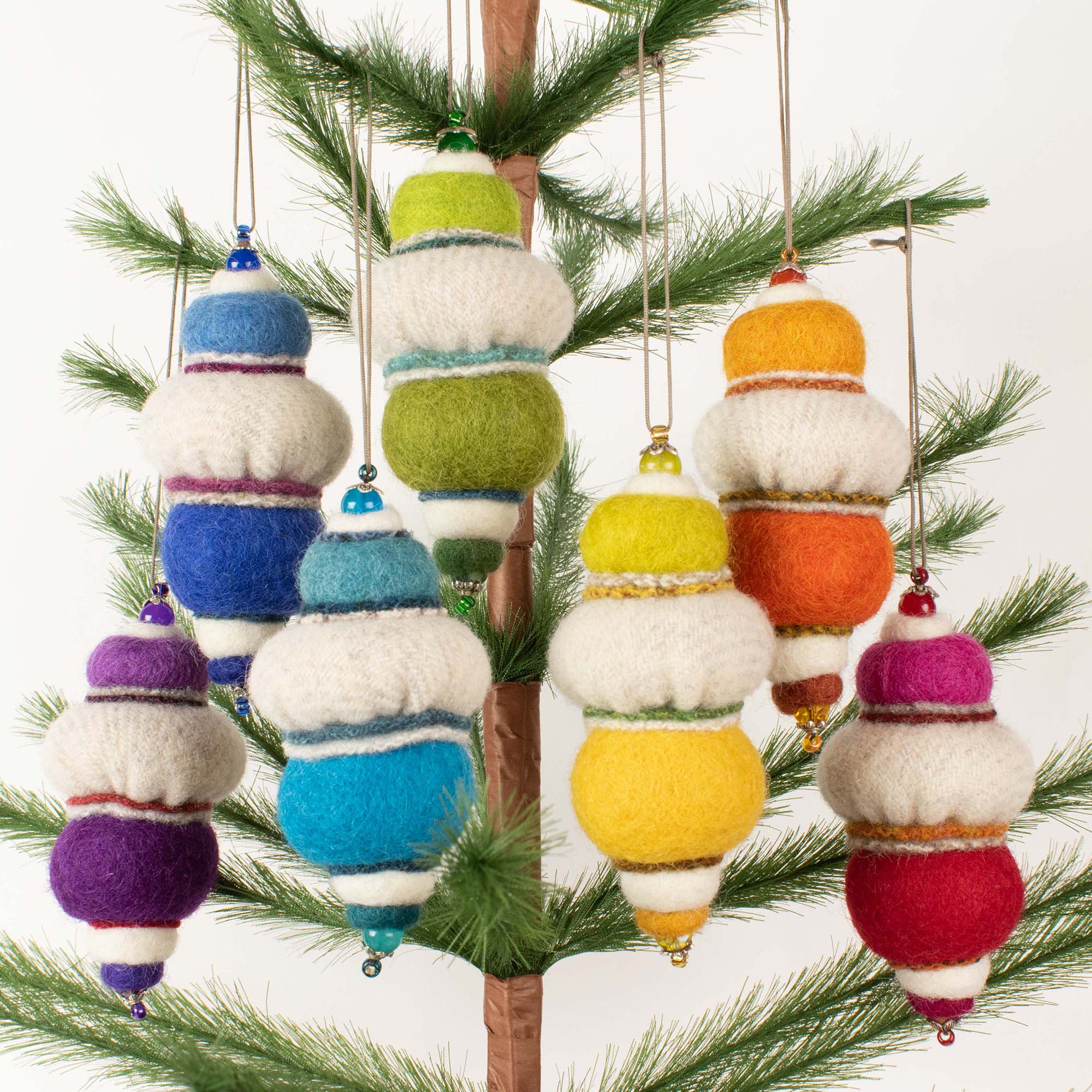 colourful fabric Christmas tree ornaments hanging on artificial tree