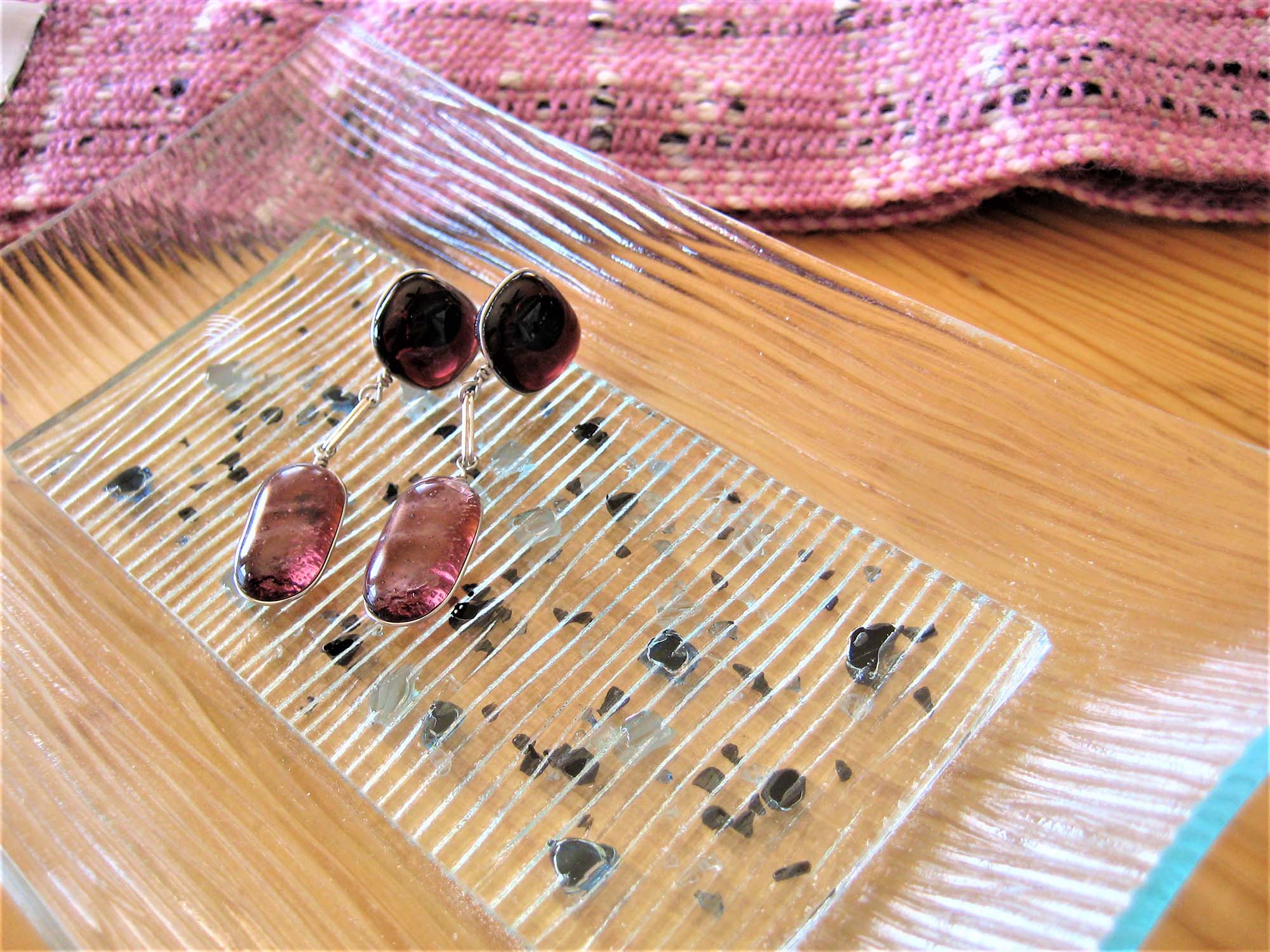glass tray on table holding earrings