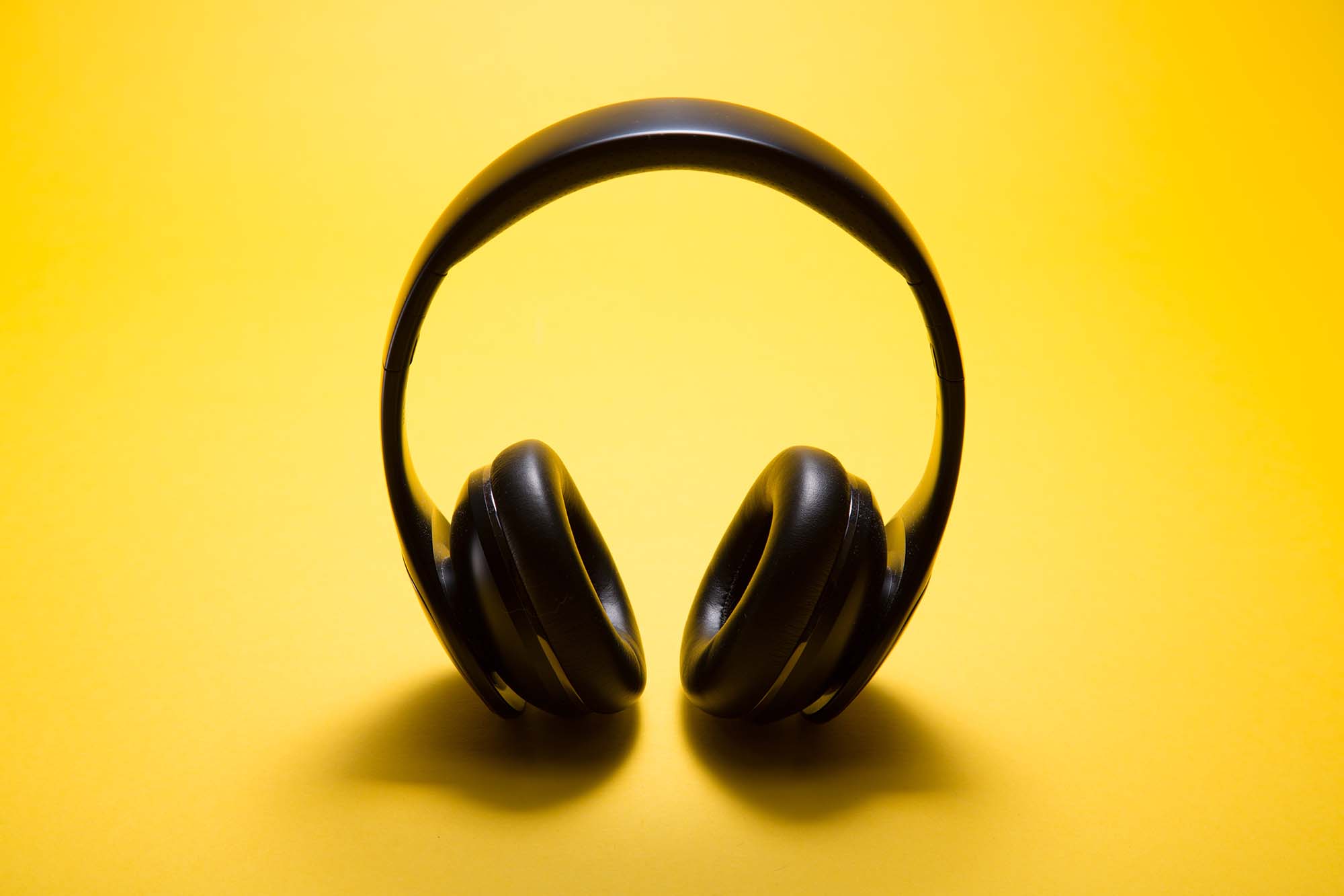 black headphones on a yellow background