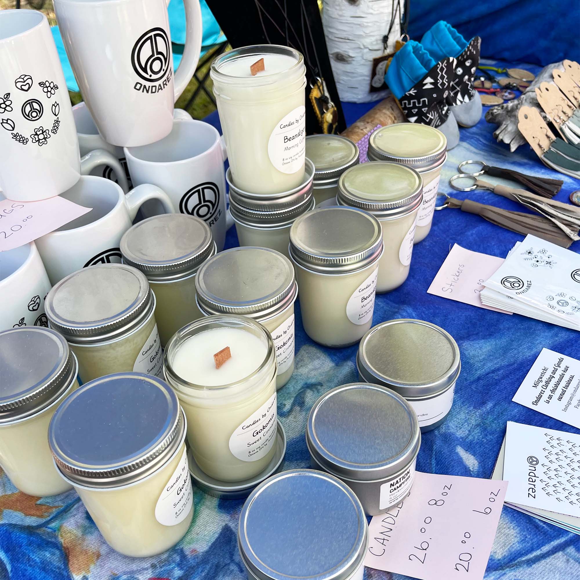 Candles and mugs on a table, in a craft fair display